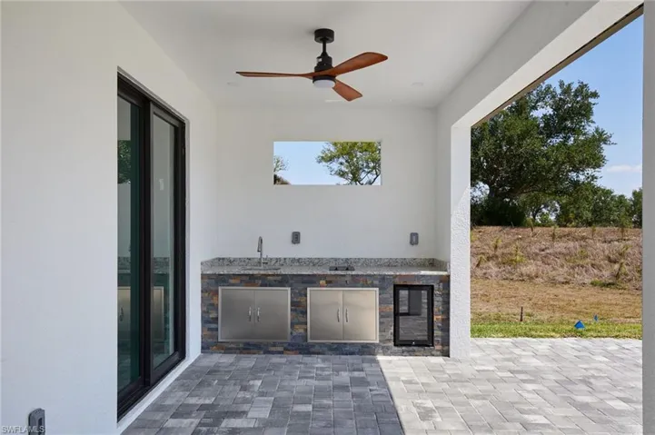 View of patio / terrace featuring a sink, area for grilling, and ceiling fan