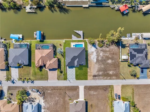 Aerial view of residential area featuring a nearby body of water