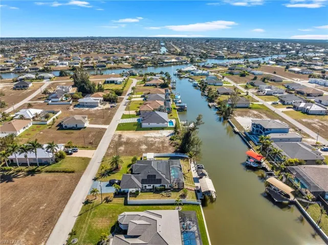 Aerial view of property's location featuring nearby suburban area and a large body of water