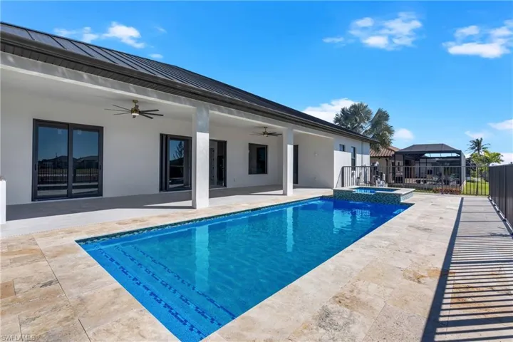 Combined pool / hot tub with a patio