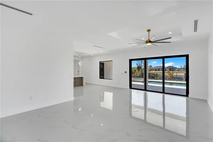 Empty room with light marble finish floors, a ceiling fan, and recessed lighting