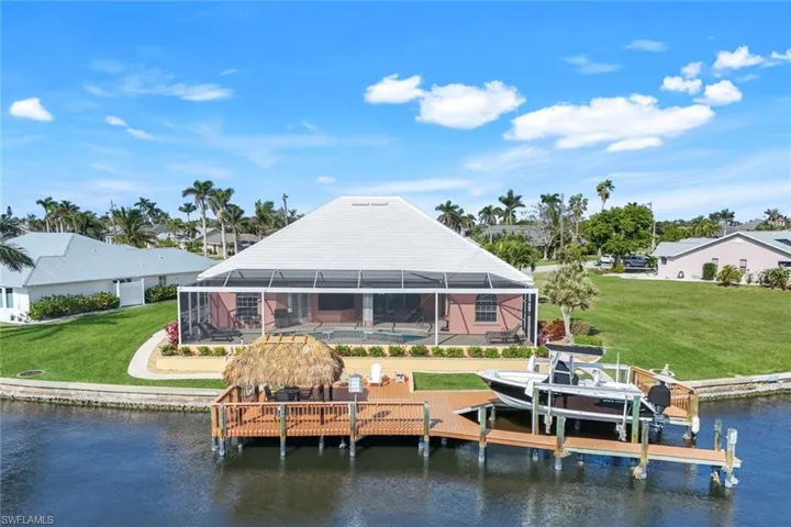 Back of house with dock and Tiki Hut