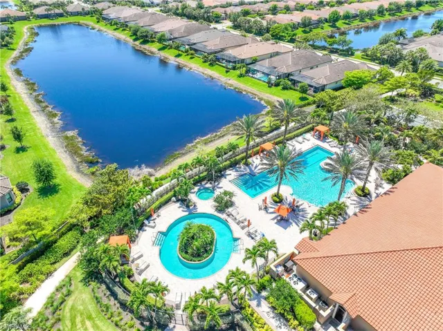 Aerial view of residential area featuring a nearby body of water