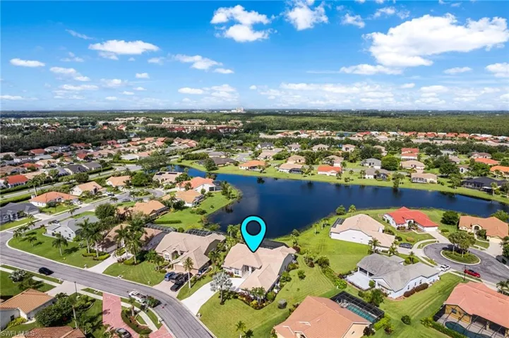 Birds eye view of property with a water view