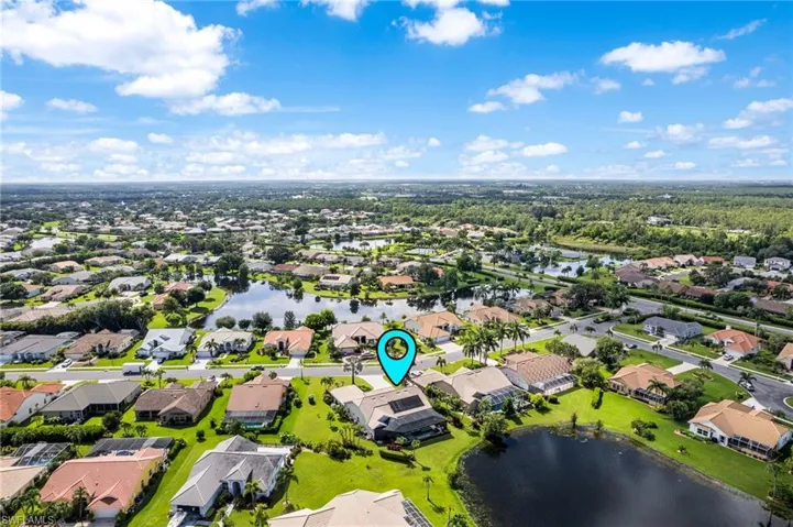 Birds eye view of property with a water view