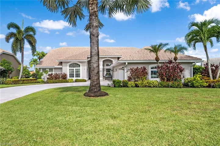 Mediterranean / spanish home with a front lawn