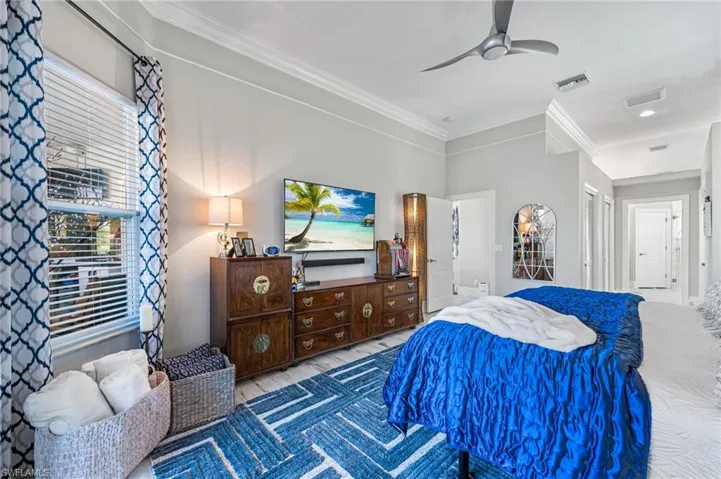 Bedroom featuring ornamental molding and ceiling fan
