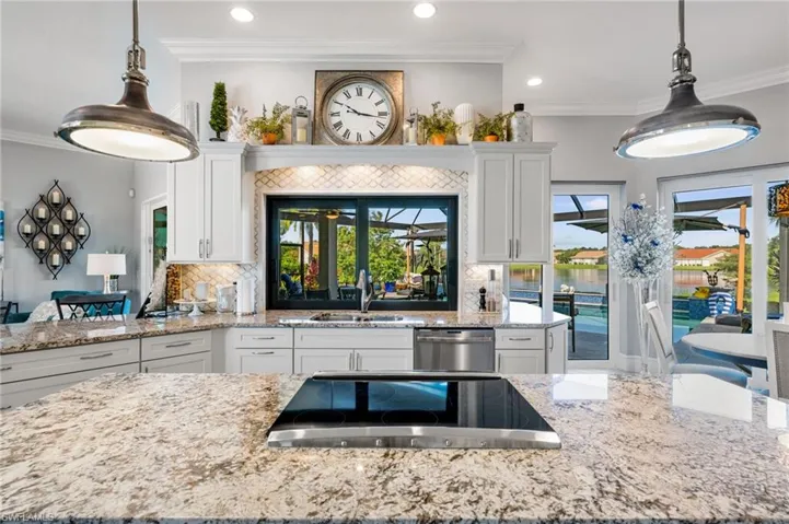 Kitchen featuring white cabinetry, dishwasher, decorative backsplash, sink, and ornamental molding