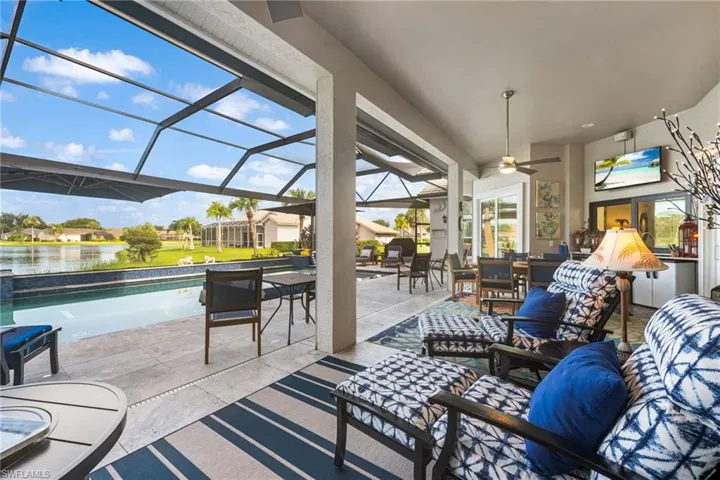 Sunroom / solarium featuring a water view and ceiling fan