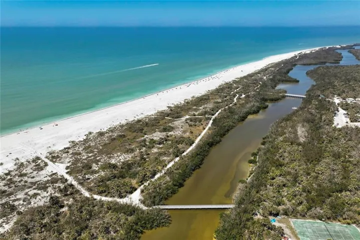 Drone / aerial view featuring a water view and a beach view