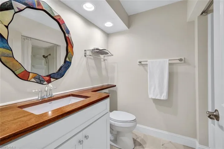 This second bathroom has a pretty tile floor and walk in shower.