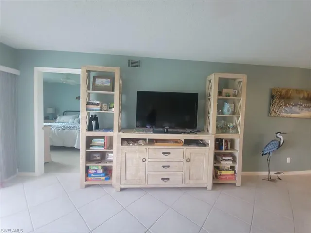 Large entertainment center and neutral tile for easy living