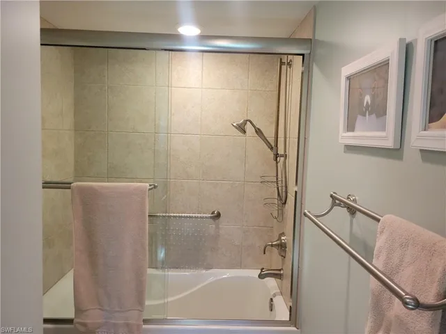 Soaker tub with shower in primay ensuite bathroom.