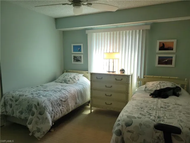Middle bedroom with closet, window and entry door