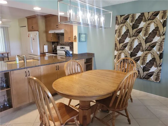 Dining room with table that opens to seat more people. Extra cabinets for easy entertaining