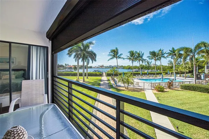 Balcony featuring view of pool area