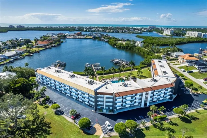 Aerial view of apartment complex and a nearby body of water