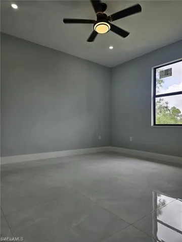 Unfurnished room with concrete floors, baseboards, recessed lighting, and a ceiling fan