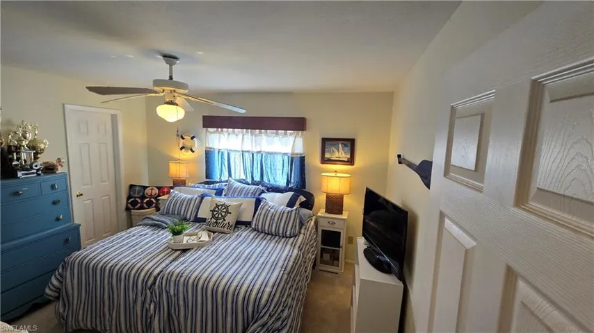 Bedroom with ceiling fan and carpet