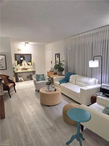Living room featuring a textured ceiling and light wood-type flooring