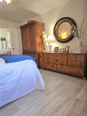 Bedroom featuring a textured ceiling and light hardwood / wood-style floors