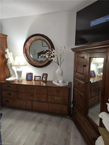 Room details with hardwood / wood-style floors and a textured ceiling