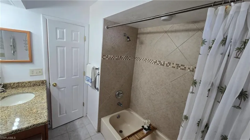 Bathroom featuring shower / bath combo, vanity, and tile patterned floors