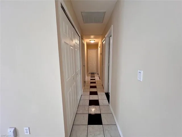 Hallway featuring light tile patterned floors
