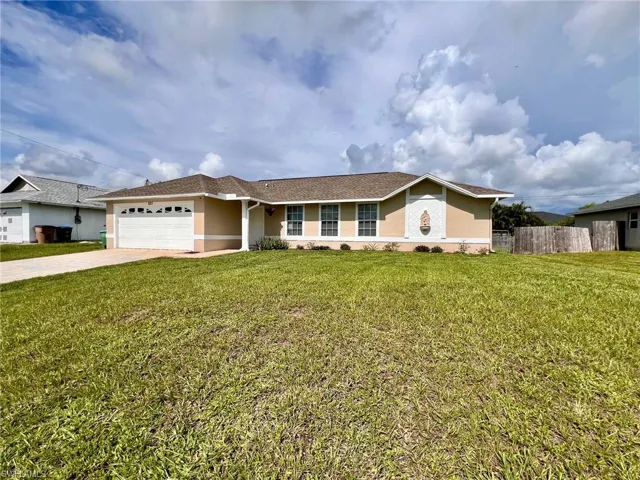 Single story home featuring stucco siding, an attached garage, and concrete driveway