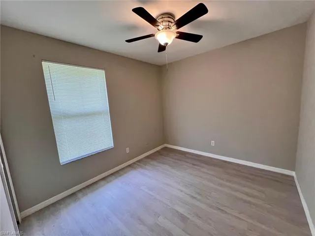 Empty room with light wood-type flooring and ceiling fan