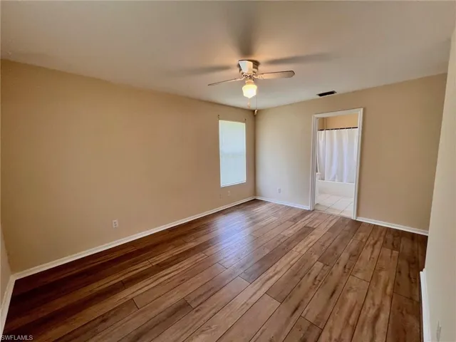 Empty room featuring light wood-style floors and ceiling fan