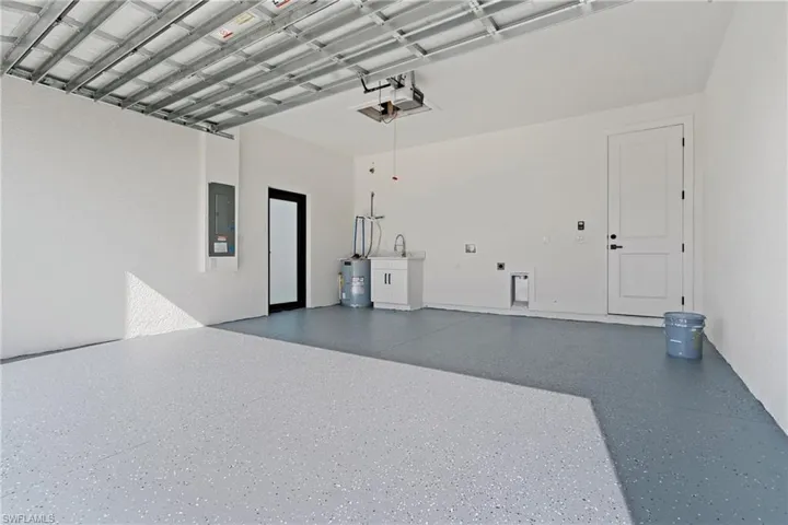 Garage with water heater and electric panel