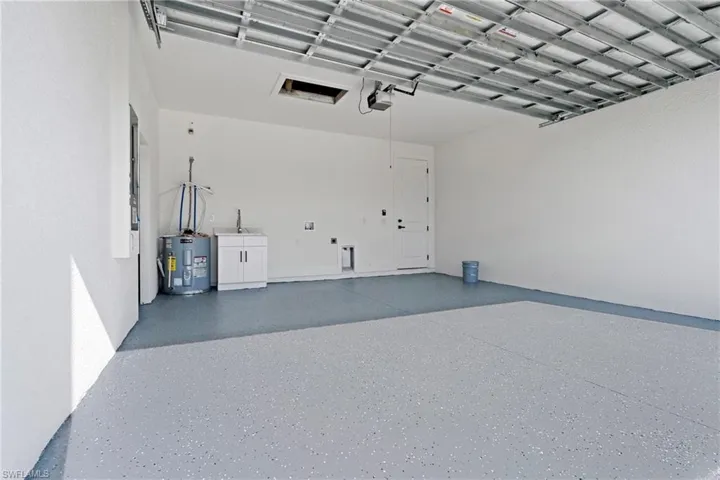 Garage with a garage door opener and electric water heater