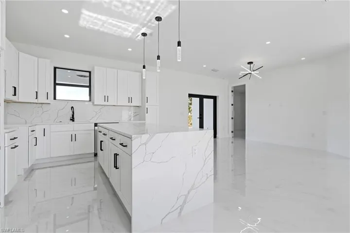 Kitchen with a healthy amount of sunlight, recessed lighting, and marble finish floor
