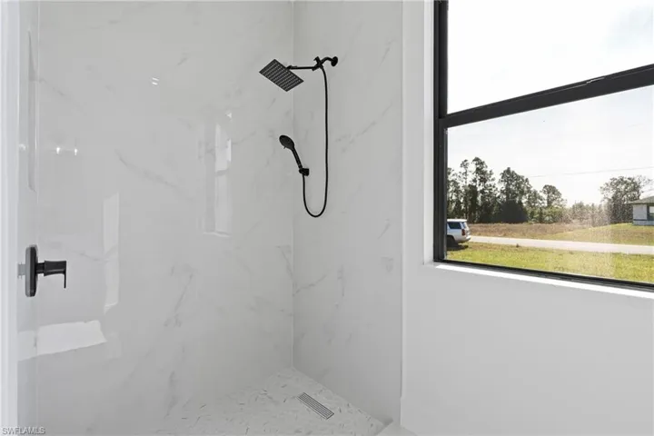 Bathroom featuring a marble finish shower