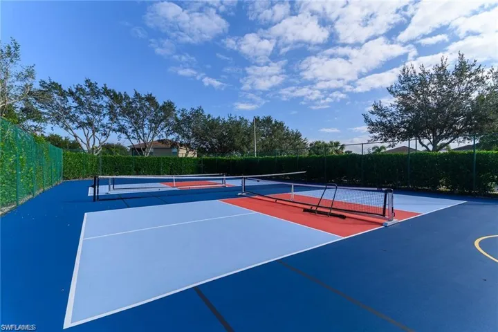 Two multi-sport courts featuring blue, light blue, and red surfacing with white and yellow line markings