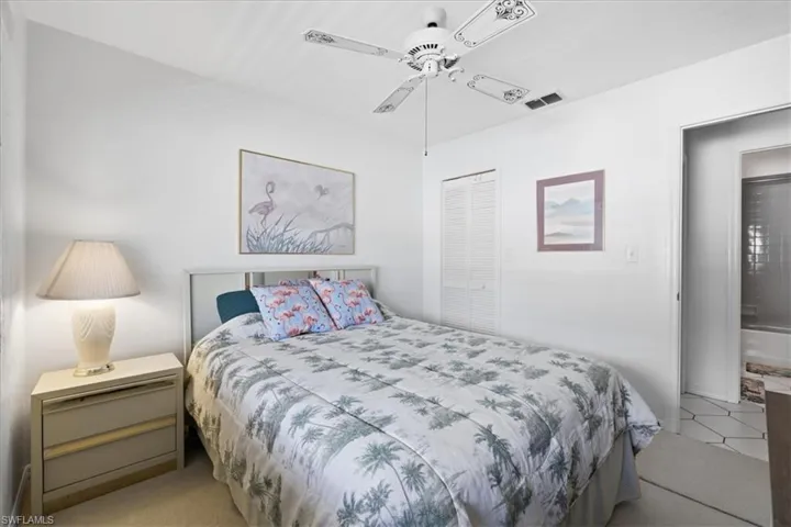 Bedroom featuring a ceiling fan, a closet, and light carpet
