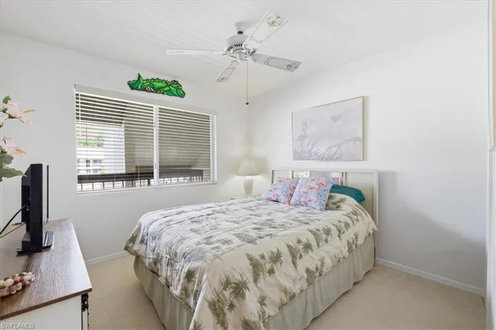 Bedroom featuring ceiling fan and light colored carpet
