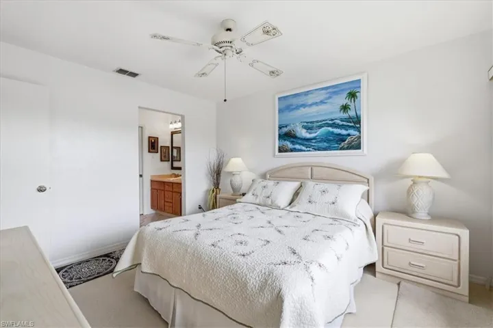 Bedroom with ceiling fan and connected bathroom