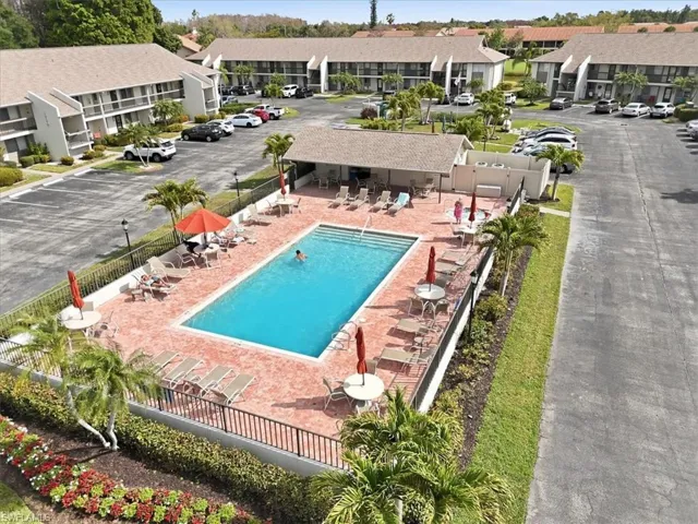 Community pool featuring a patio and a residential view