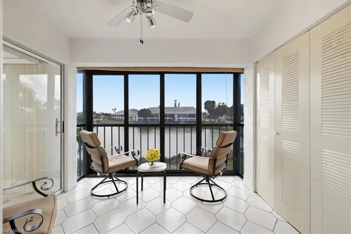 Sunroom / solarium featuring plenty of natural light and a water view