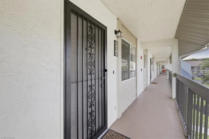 Doorway to property featuring stucco siding