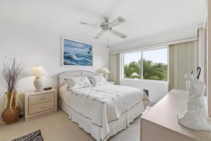 Bedroom featuring ceiling fan and light carpet
