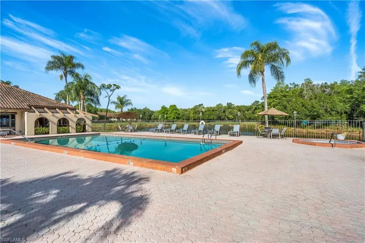 Community pool with a patio