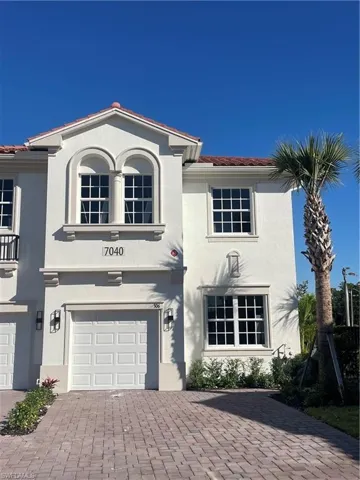 Mediterranean / spanish-style home featuring stucco siding, decorative driveway, a tiled roof, and an attached garage