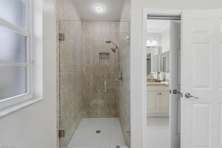Bathroom with a stall shower, vanity, and light tile patterned floors