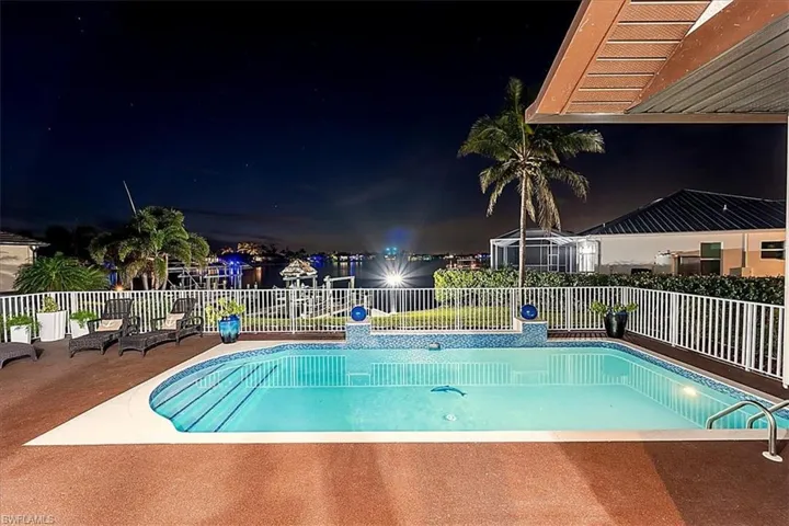 Pool at night with a patio