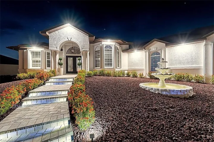 View of front of home with french doors and stucco siding