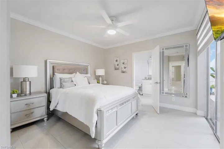 Bedroom featuring ornamental molding, light tile patterned floors, ceiling fan, and access to outside