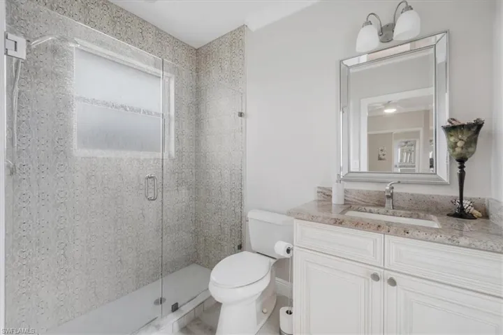 Full bath with a stall shower and vanity